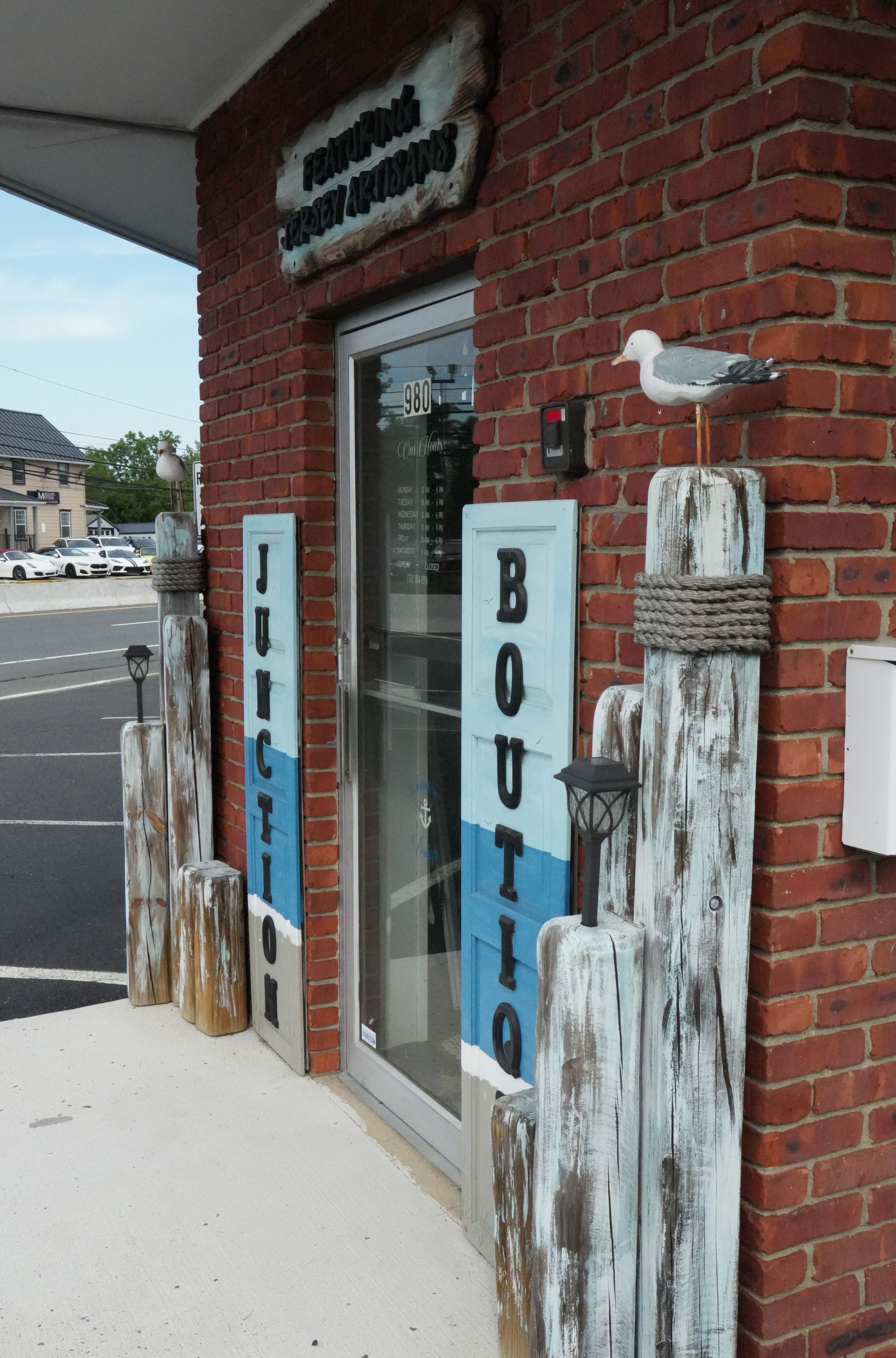 Junction Boutique's front door and hand-painted entrance signs against the brick storefront